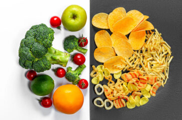 Lifestyle Choice Concept. Healthy food on white and junk food on a black background. Top view