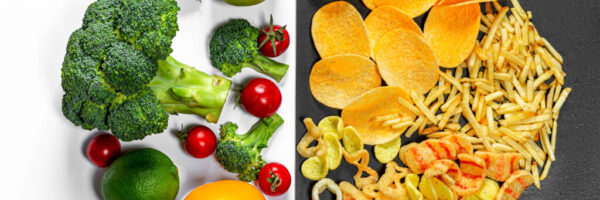 Lifestyle Choice Concept. Healthy food on white and junk food on a black background. Top view
