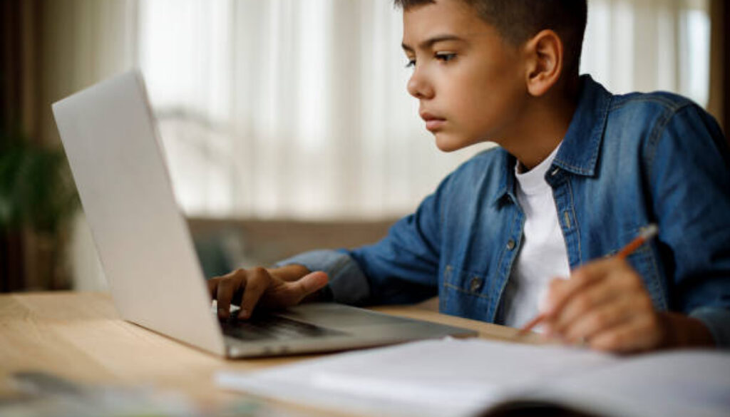 Teenage boy using laptop for homework