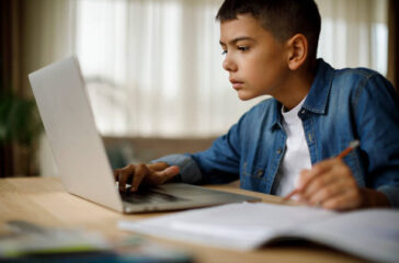 Teenage boy using laptop for homework