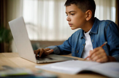 Teenage boy using laptop for homework