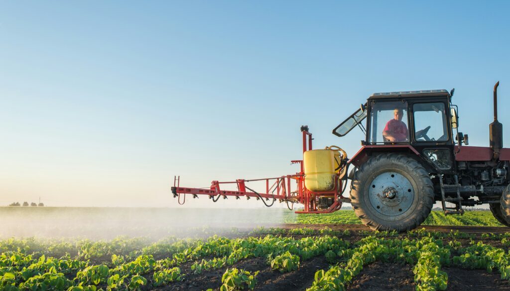 Farmer spraying a soybean field.