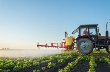 Farmer spraying a soybean field.