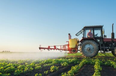 Farmer spraying a soybean field.
