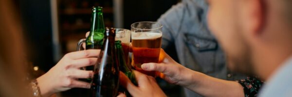 getty-images-ttE23un-9BI-unsplash People doing a cheers with their beers.
