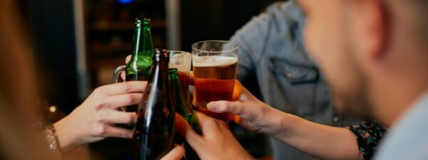 getty-images-ttE23un-9BI-unsplash People doing a cheers with their beers.