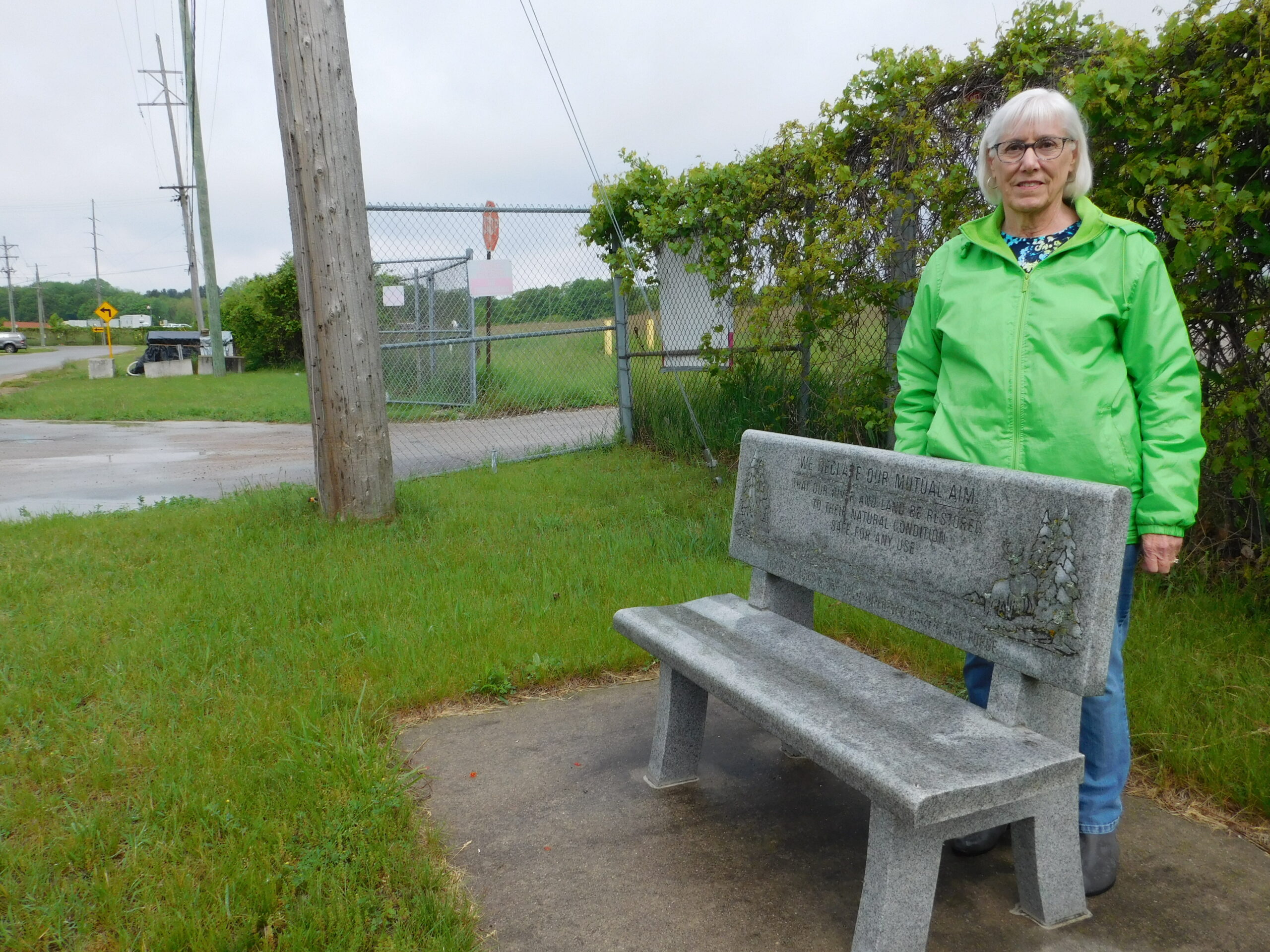 Jane Keon, a local author and founding member of Pine River Superfund Citizen Task Force, stands near the entrance to the former Velsicol plant Superfund site