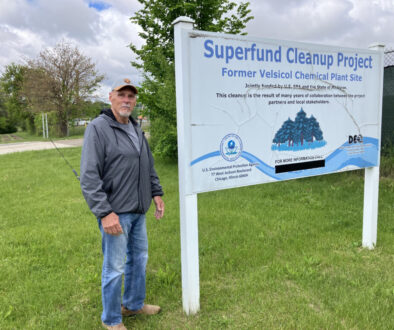 Gary Smith of St. Louis, Michigan, stands near the Superfund site sign at the former Velsicol plant.