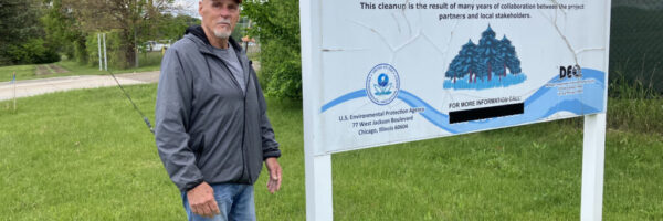 IMG_4245 2 Gary Smith of St. Louis, Michigan, stands near the Superfund site sign at the former Velsicol plant.