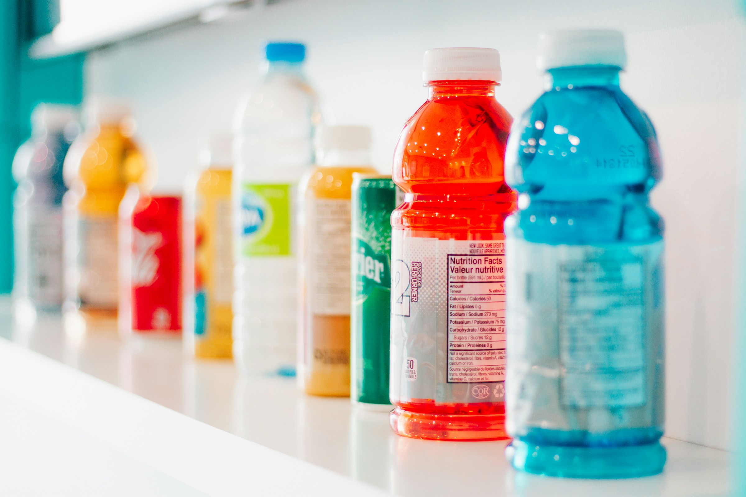 a shelf full of beverages including gatorade